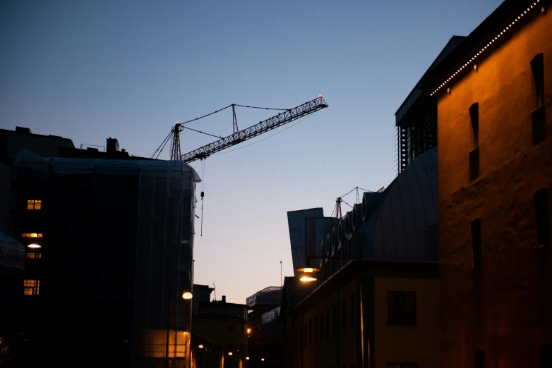 a construction crane that is standing above a street