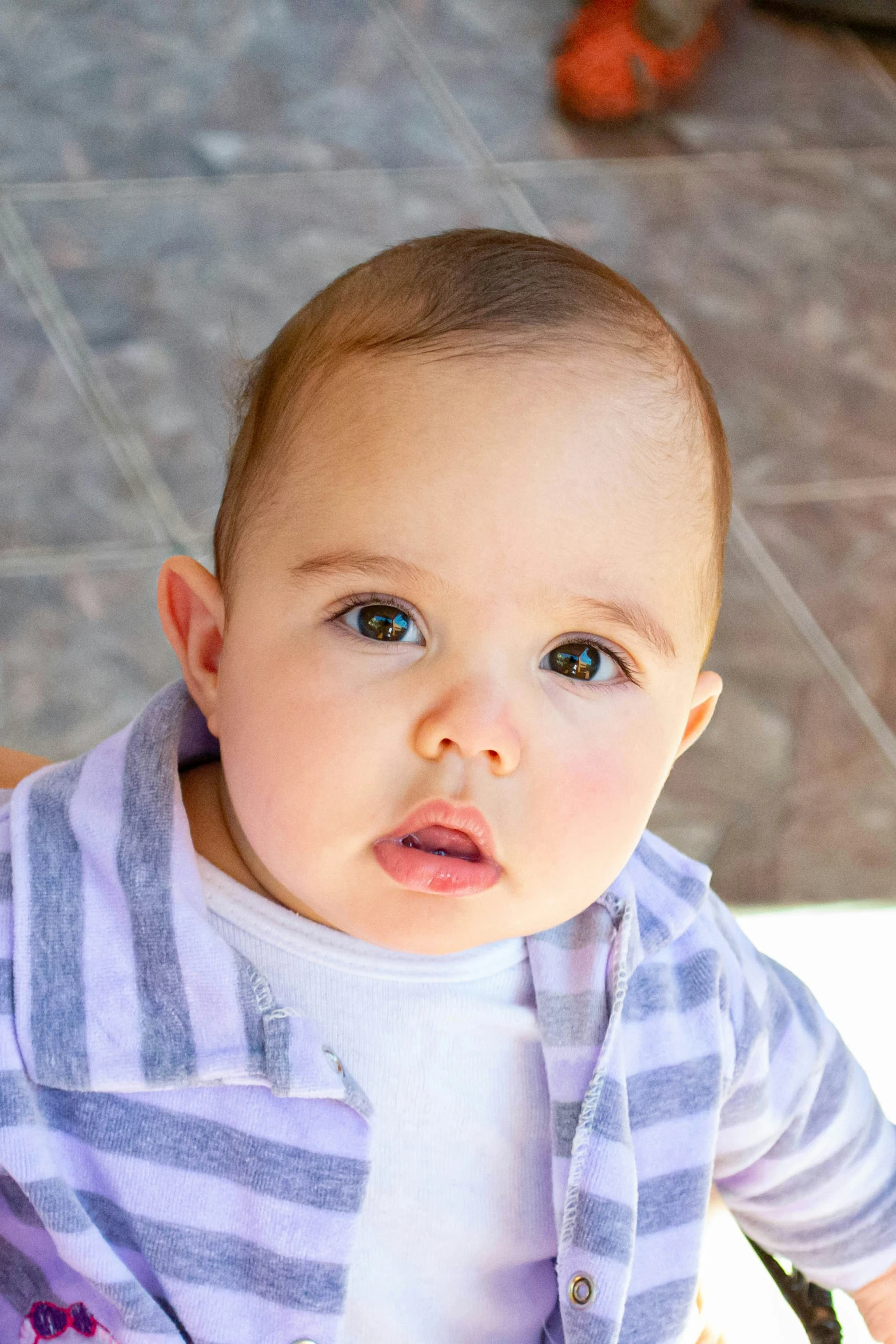 a young baby standing next to the floor