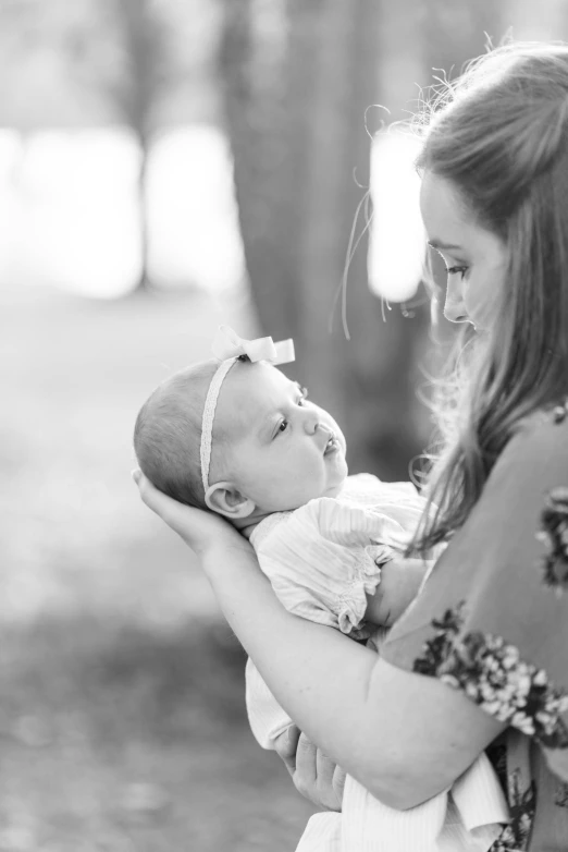 a young woman is holding her baby girl