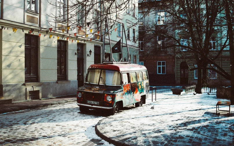 a small van on a snowy city street