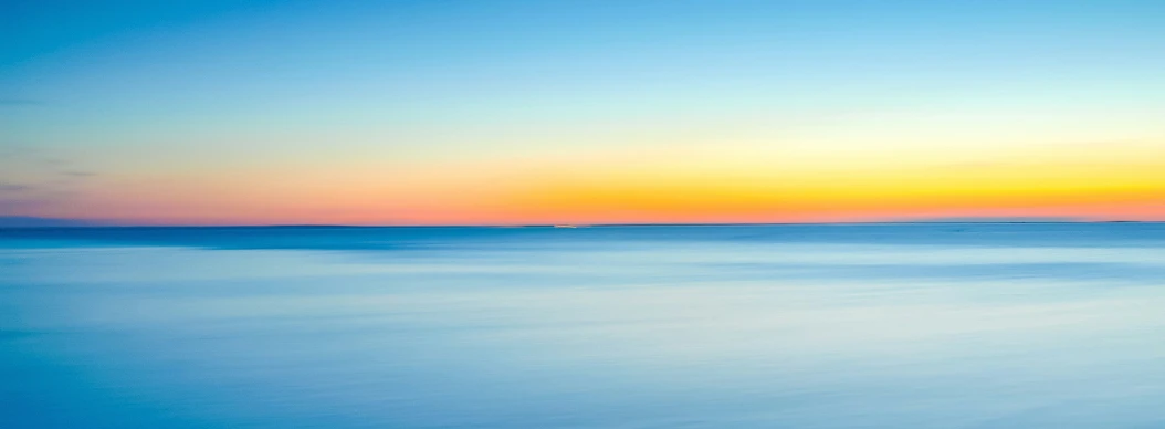 the sky is reflected in a wide body of water