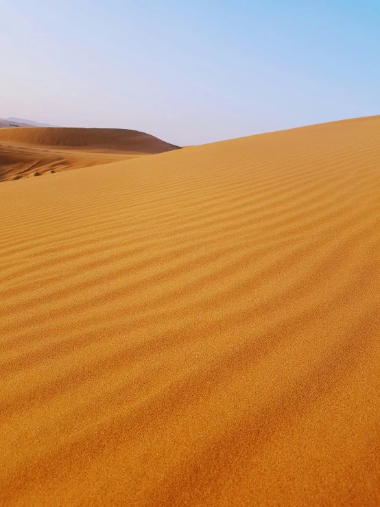 sand dunes with hills in the background