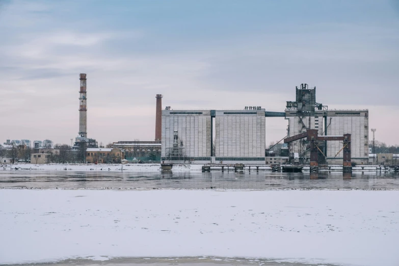 some very big tall industrial buildings in the snow