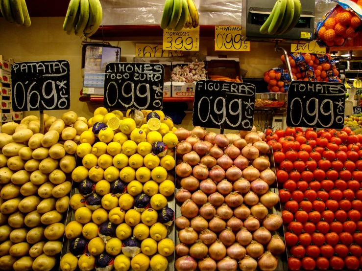 several varieties of fruits and vegetables in an indoor market