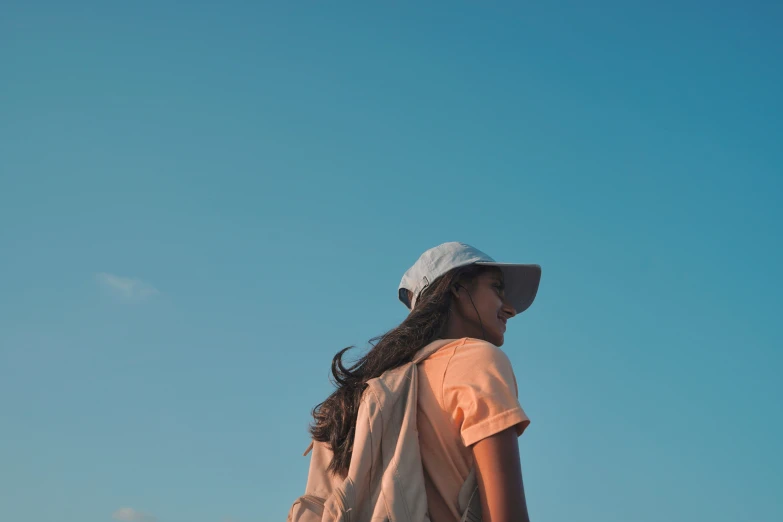 a woman is looking away from a bird in the air