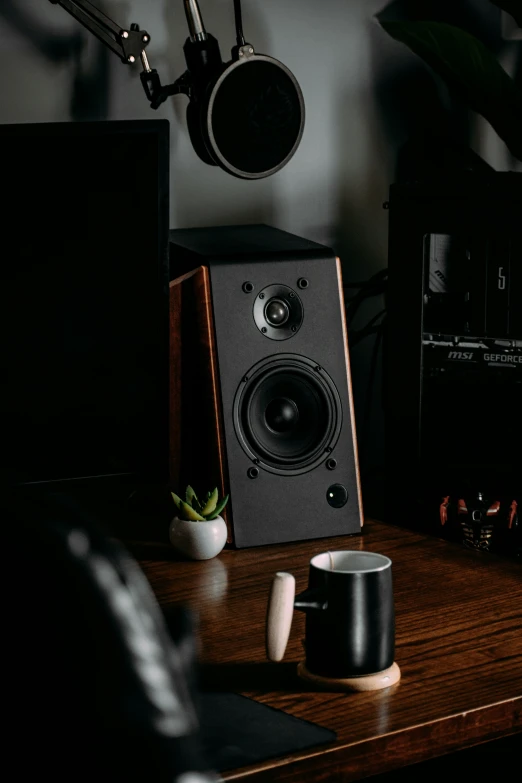 an audio player and speakers on top of a desk