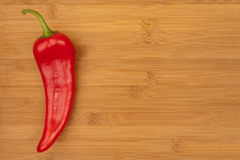 a pepper on a table ready to be cut into quarters