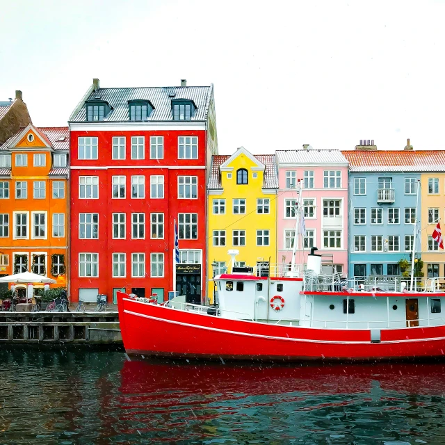 boats parked on the water beside buildings