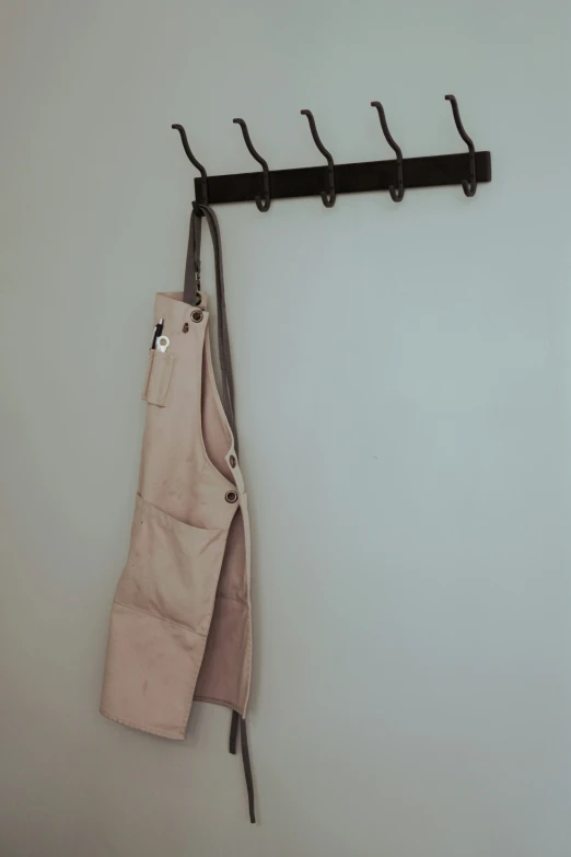 a coat hanging from a metal hook and rail