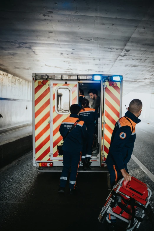 three men are standing in the back of a truck