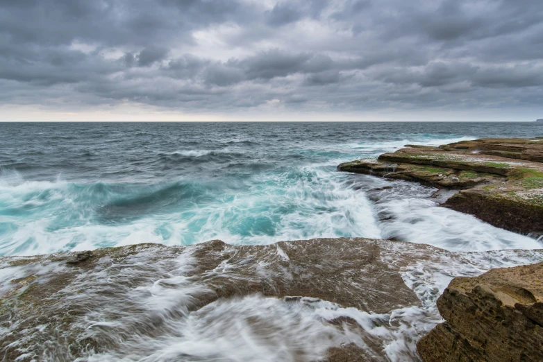 waves crashing against the rocks on the coast