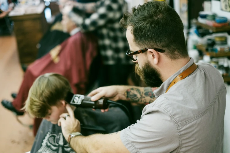 the man is doing his haircut at the barber