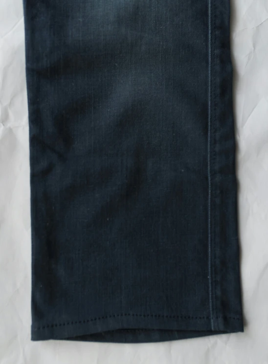 an up close po of a pair of jeans on a sheet of parchment