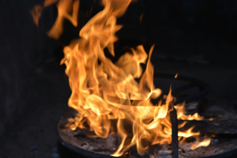 fire blazing inside an iron pot that is on fire