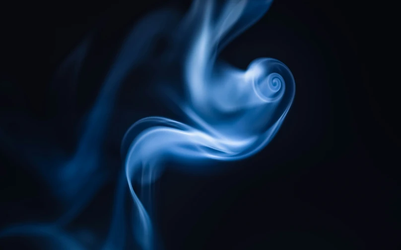 blue smoke swirls into the dark background