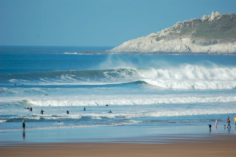 several people are surfing the waves at the beach