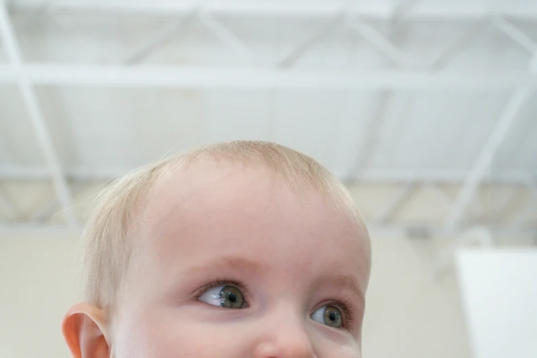 a baby with it's head turned and it is wearing a tie