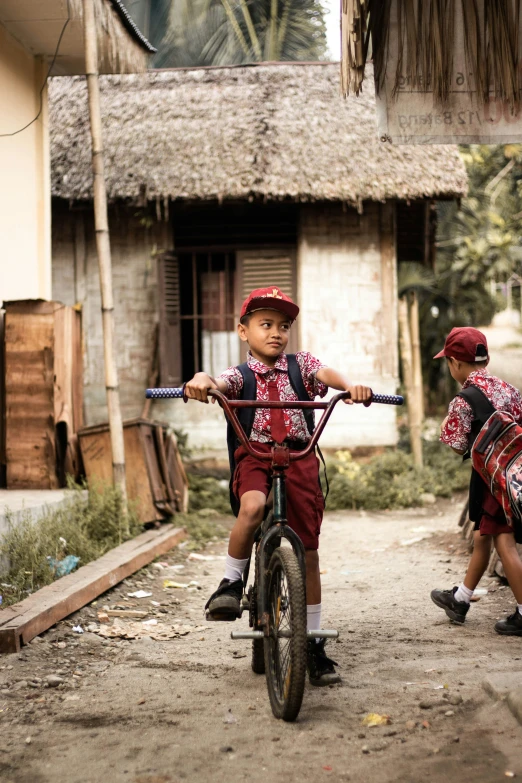 a couple of s are playing on their bikes