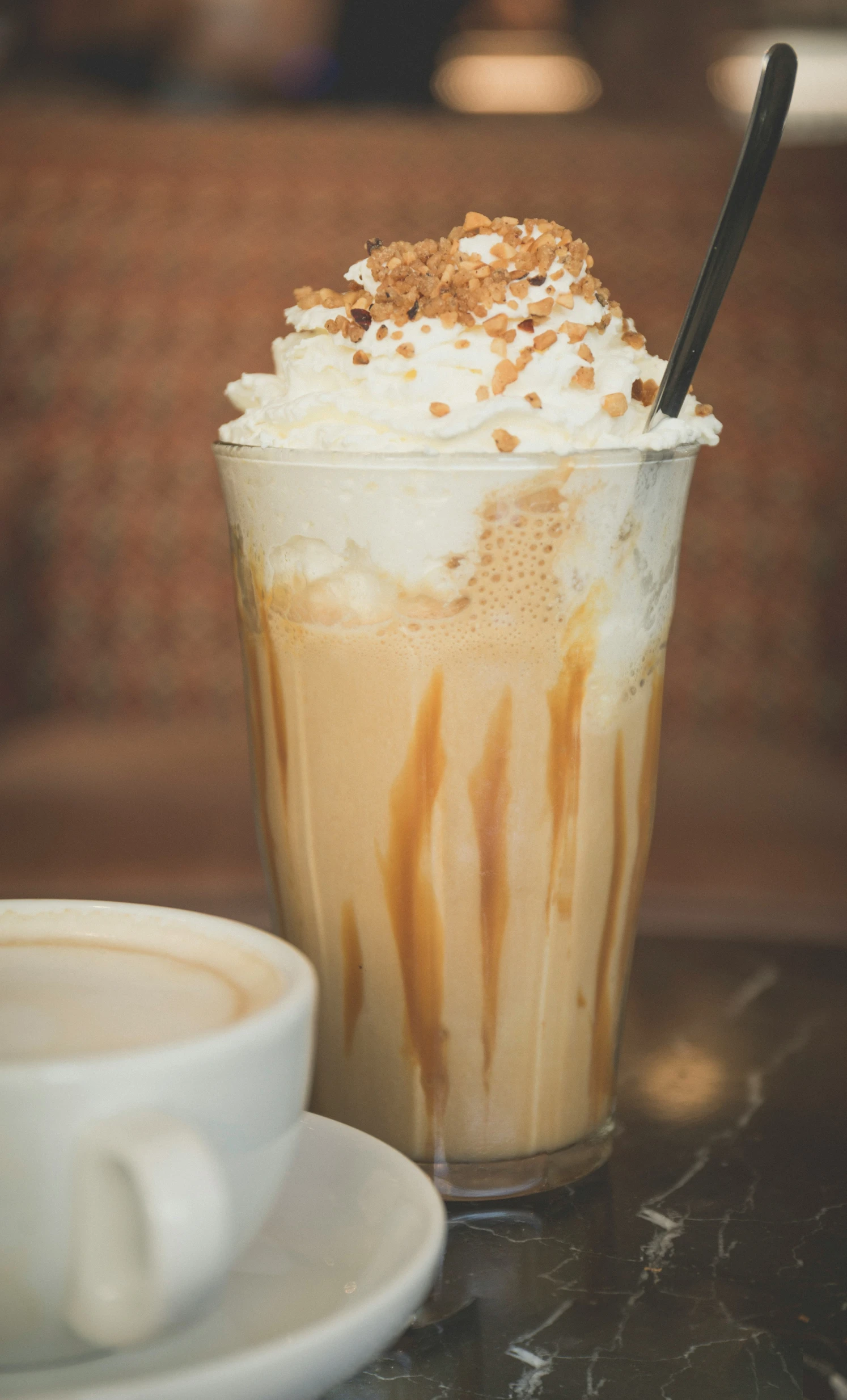 a table with a coffee drink and beverage in it