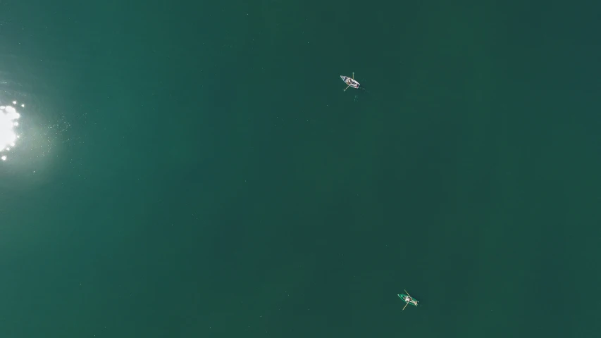 two surfers are floating in the clear water