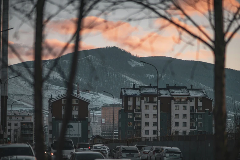 some cars stopped at an intersection on the road and mountain