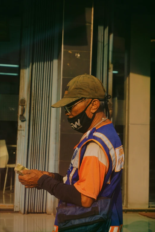 a man with a face mask holding a  dog