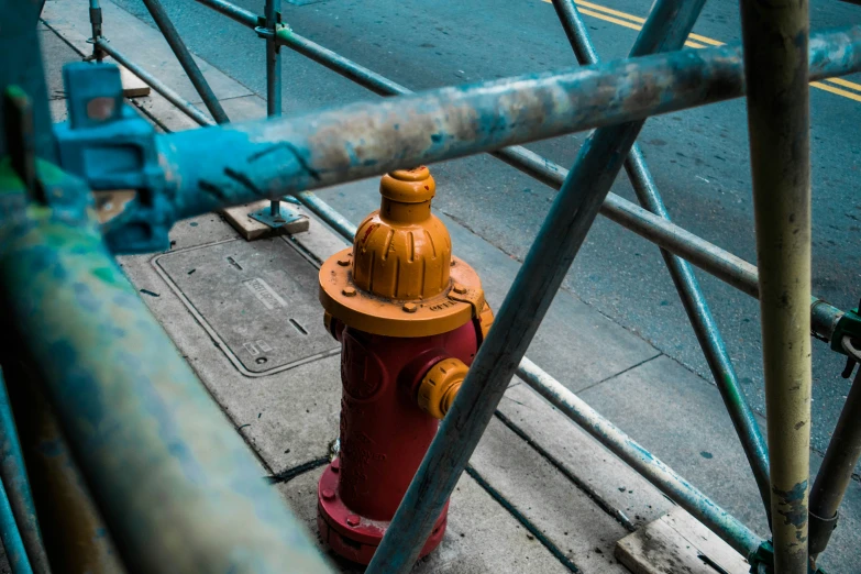 a yellow and red fire hydrant on a sidewalk