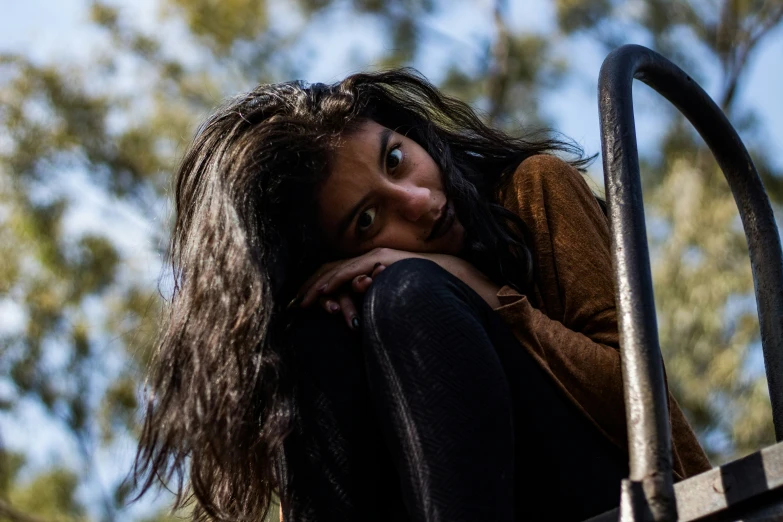 a woman with long hair sitting on a ramp