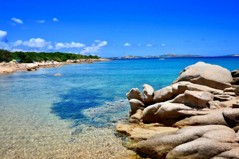 clear water with a beach on the right