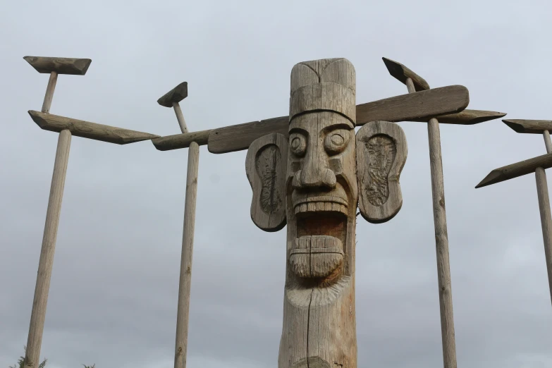 a large wooden carved mask with many birds