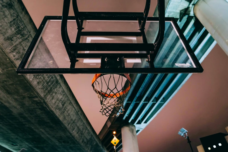 the basketball is hanging from the glass cage