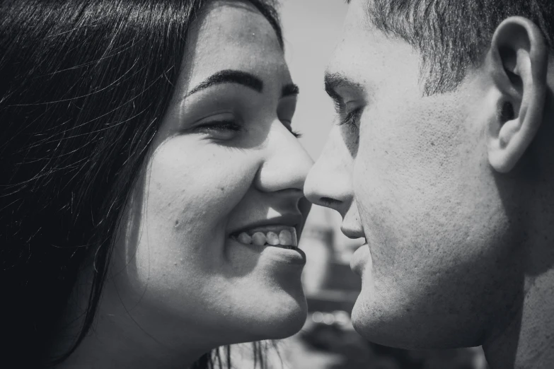 a black and white image of a man and woman