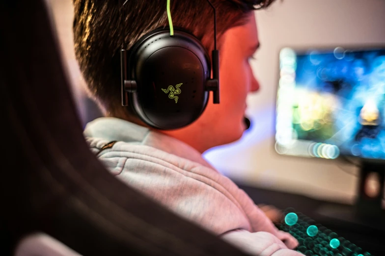 a young man with headphones is playing a video game