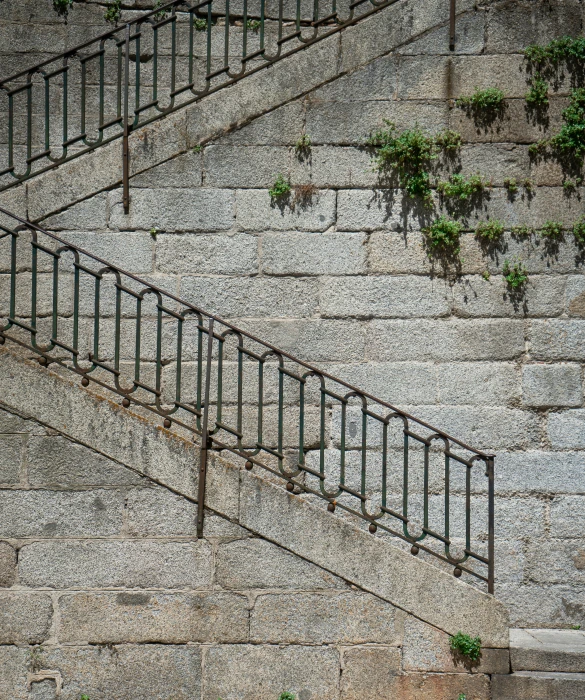 a stairwell made of iron is shown against an unfinished wall