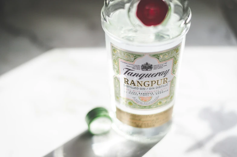 an empty bottle of gingeze on a glass table