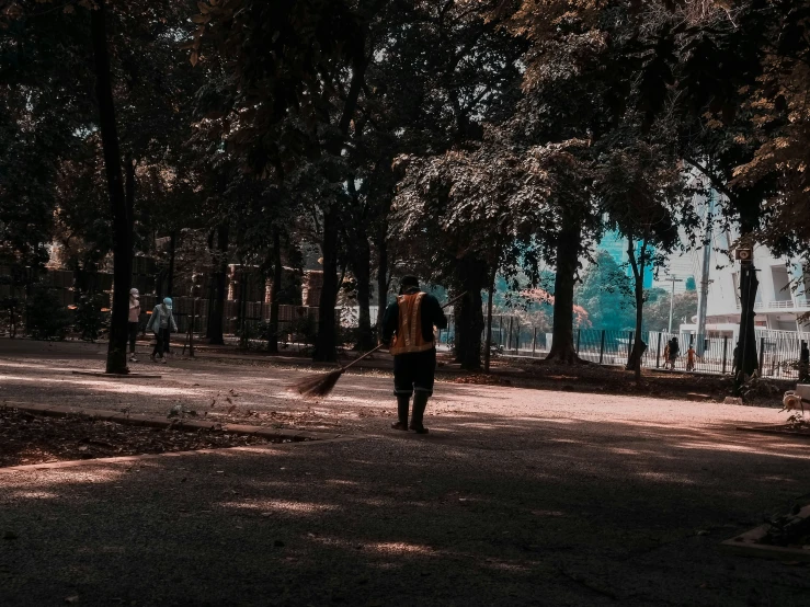 someone walking down the road through the woods