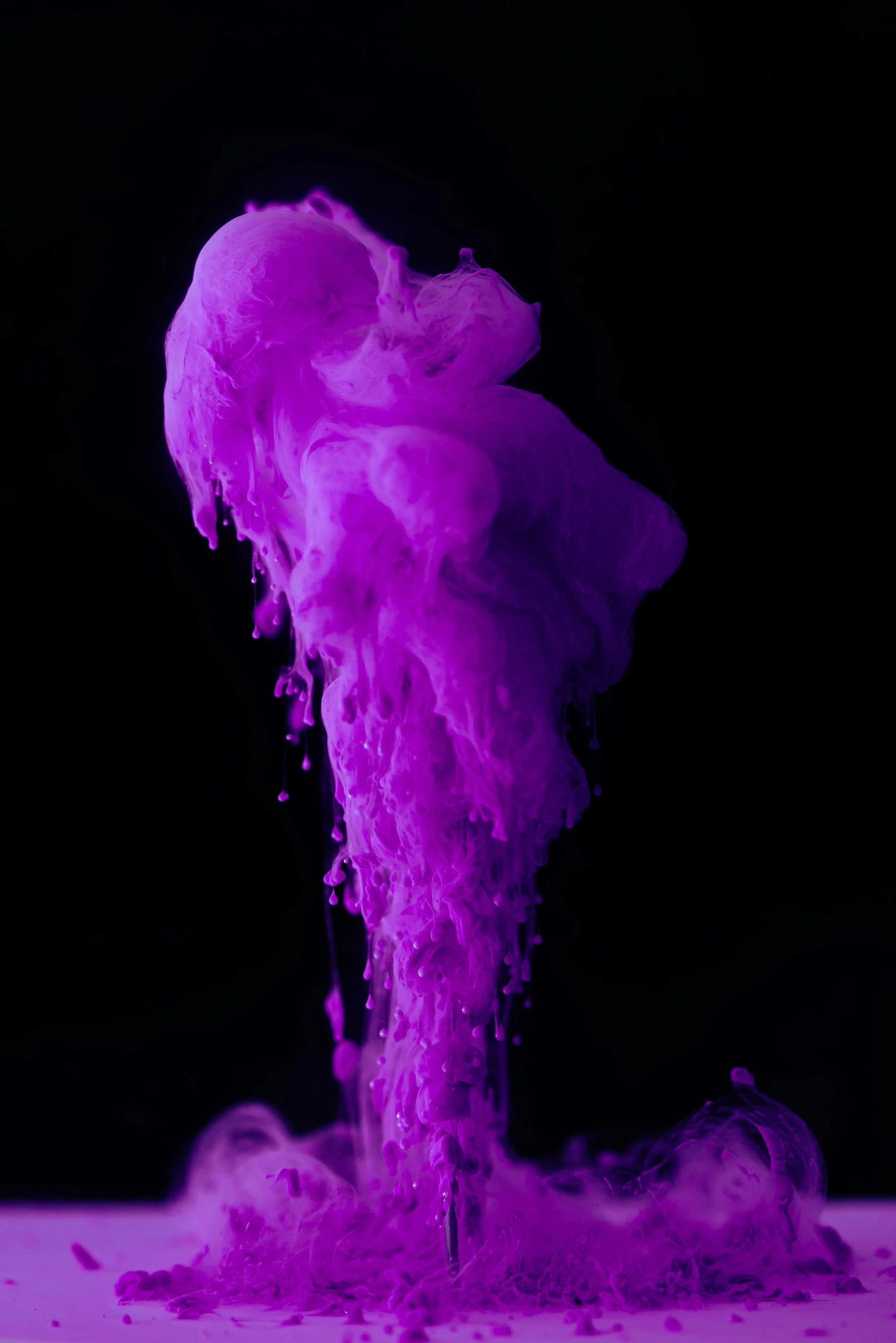 purple water is pouring in the air from a pipe