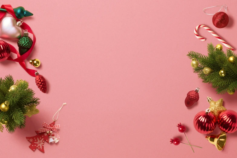 colorful christmas decorations including candy canes and star ornaments on pink background