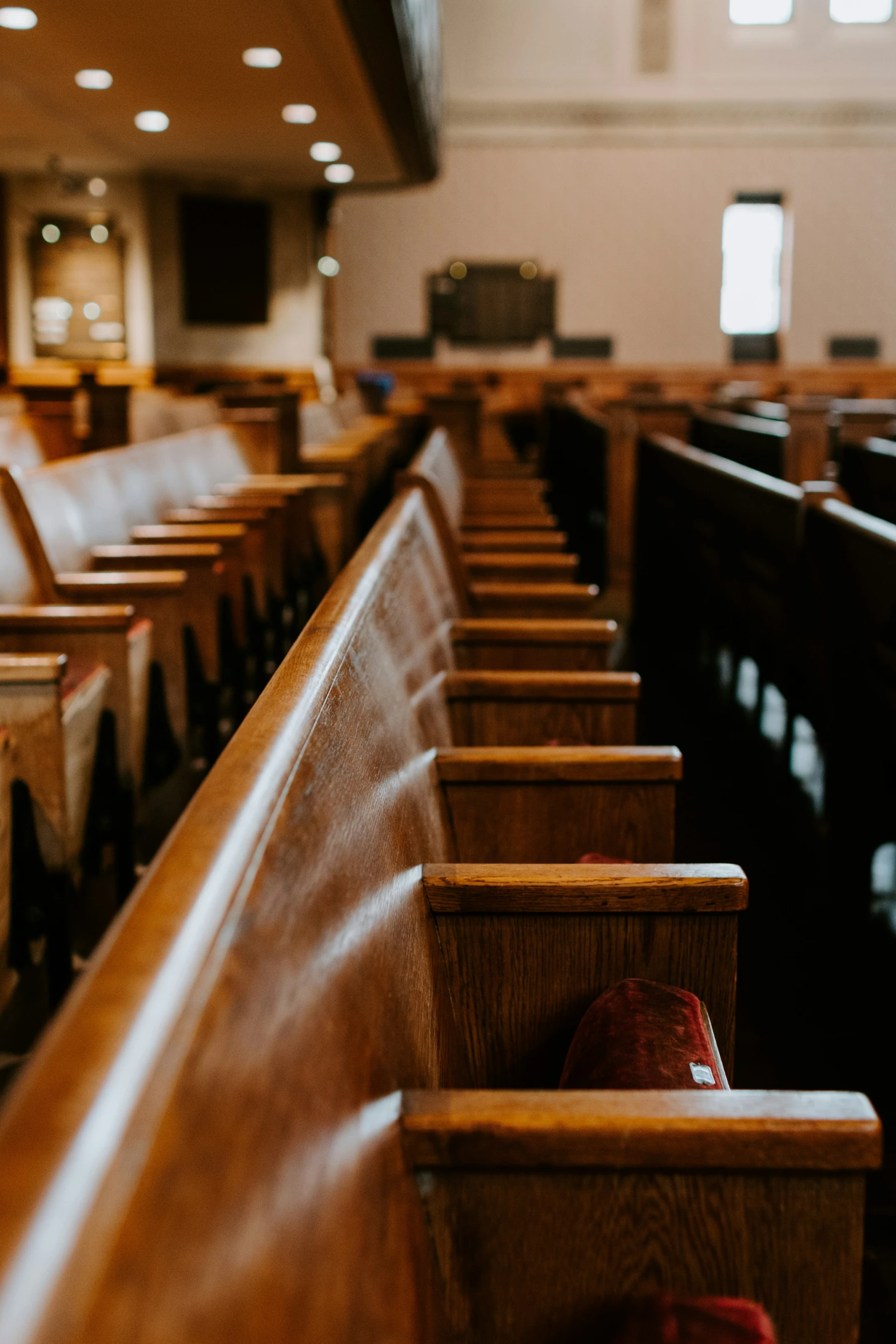 the pews at a church with red shoes on them