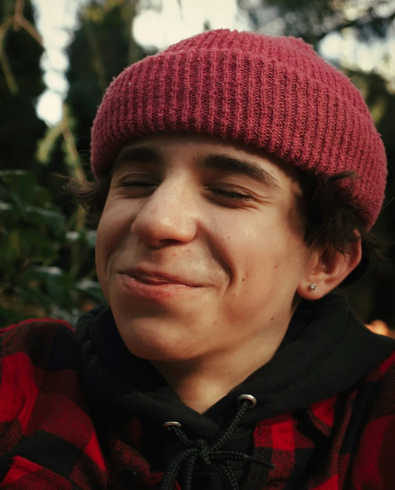 a man in a red hat poses for the camera