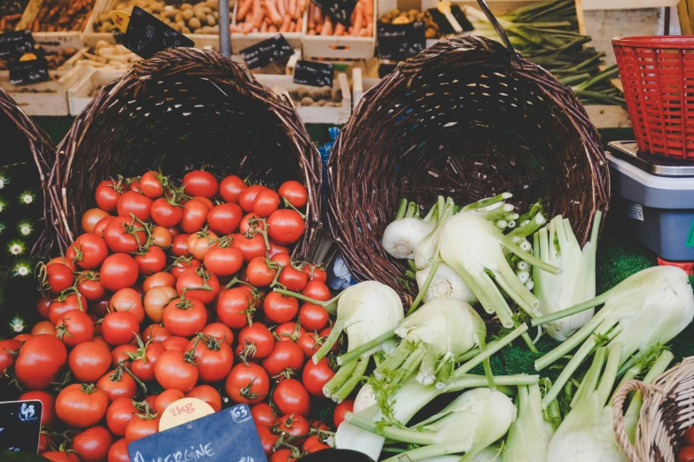 three baskets with vegetables are shown in the market