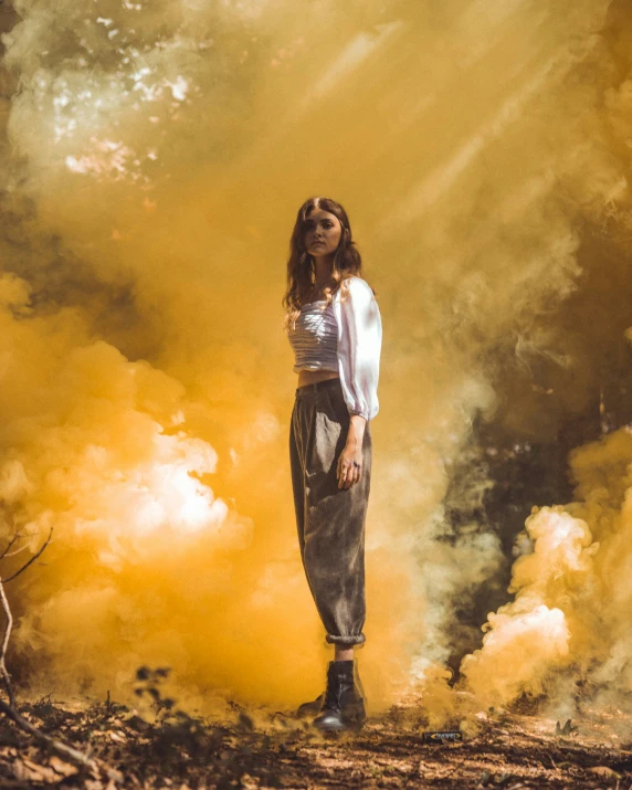 woman wearing black boots standing next to yellow smoke