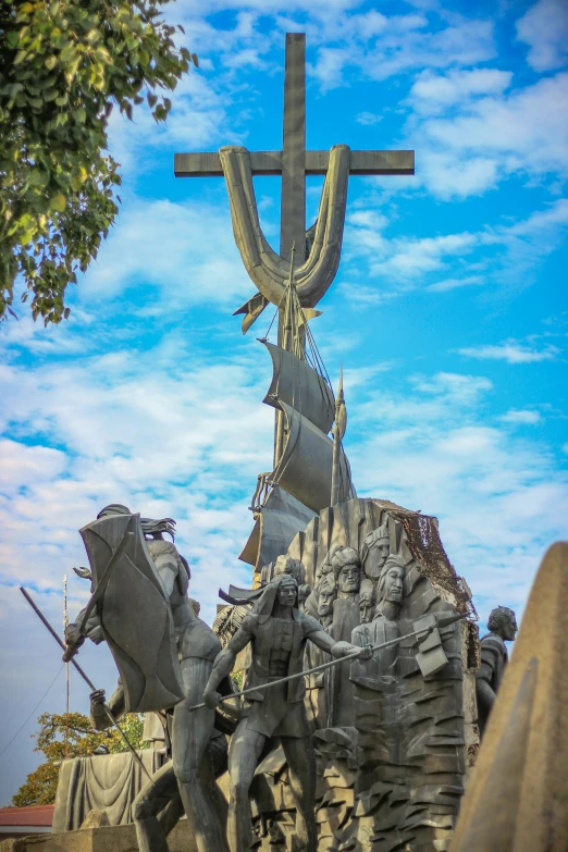 there is a sculpture with a cross on top