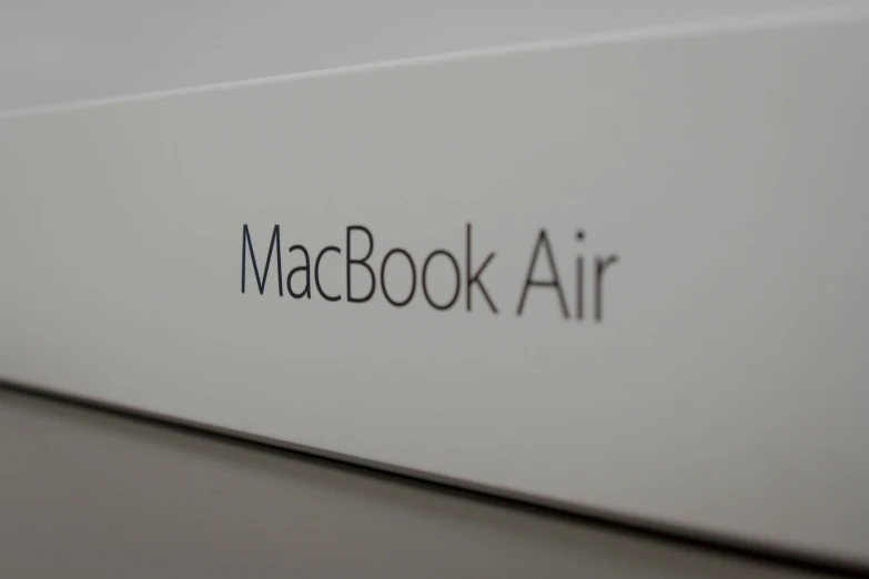 closeup po of logo on a white book with the text macbook air
