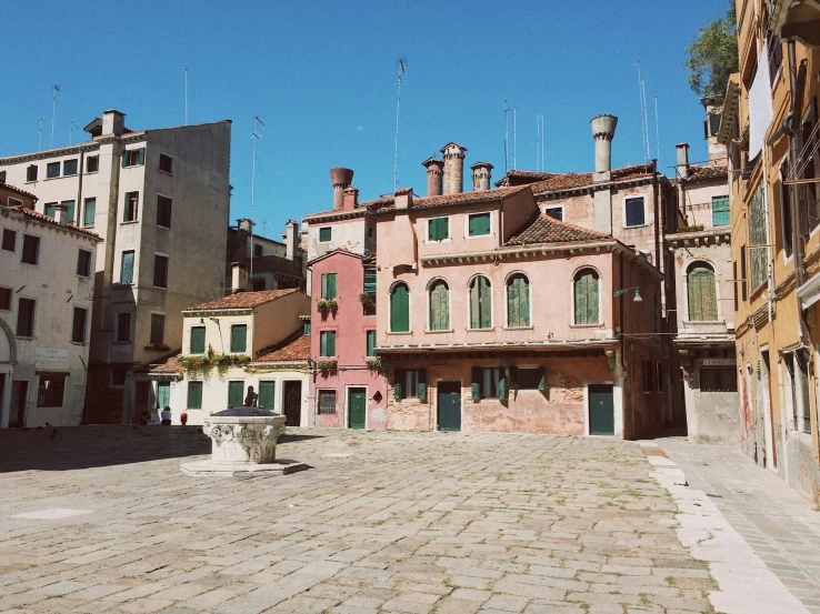 the cobblestone square and towers of this village are dotted with red brick buildings