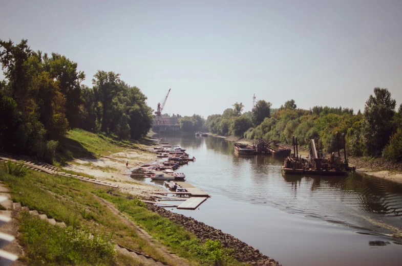 several boats in the water by a shore line