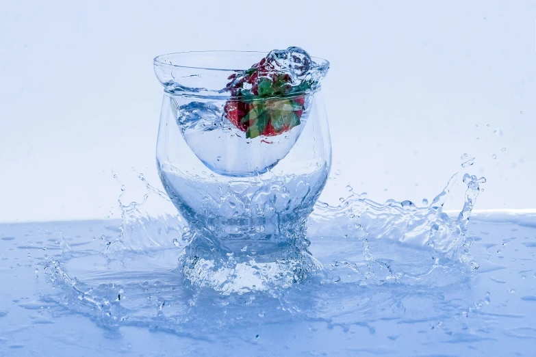 a glass filled with water has small items