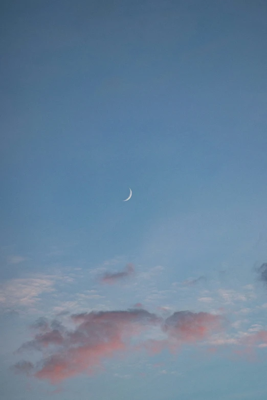 the moon and clouds are visible from an airplane