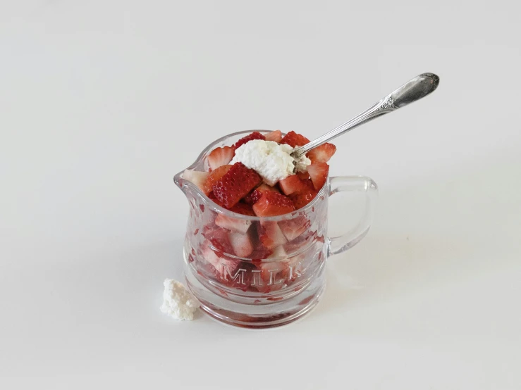 strawberries and whipped cream are in a jar