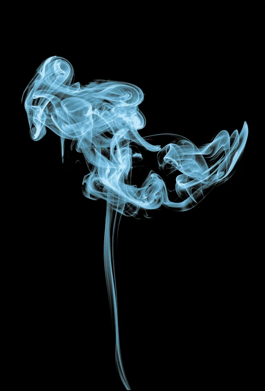 some smoke in the dark against a black background